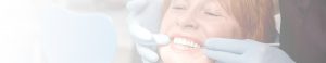 a woman examines her smile after dental implant surgery recovery